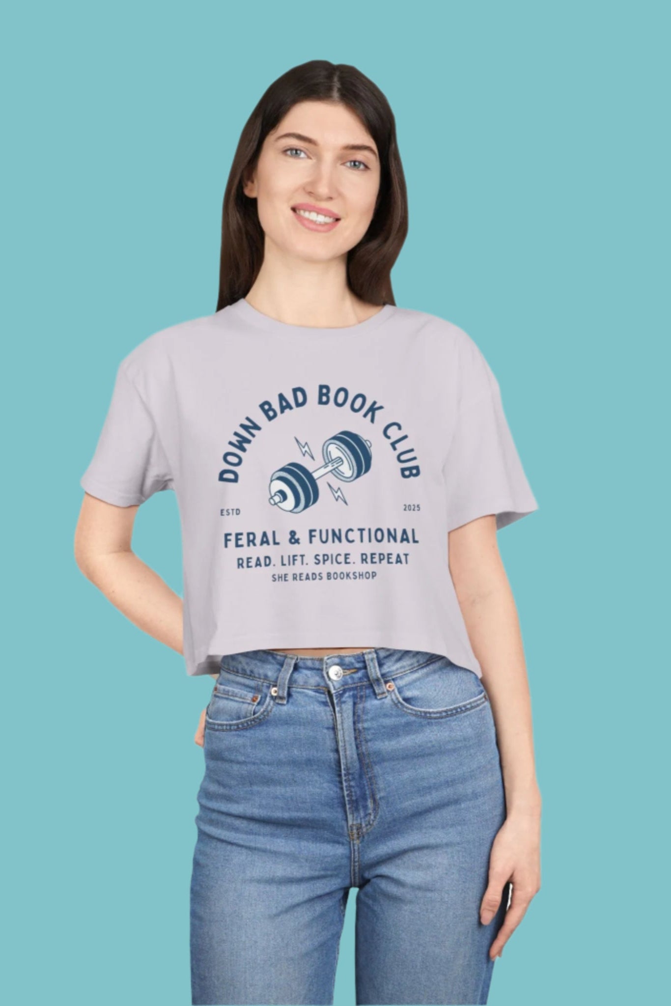 Woman wearing a gray t-shirt with text and graphics on a white background
